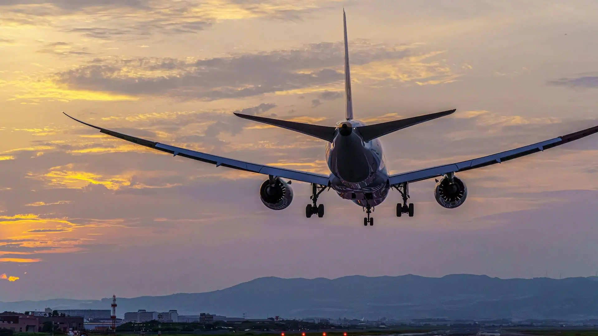 Aeroplane landing at sunset for an Umrah airport transfer